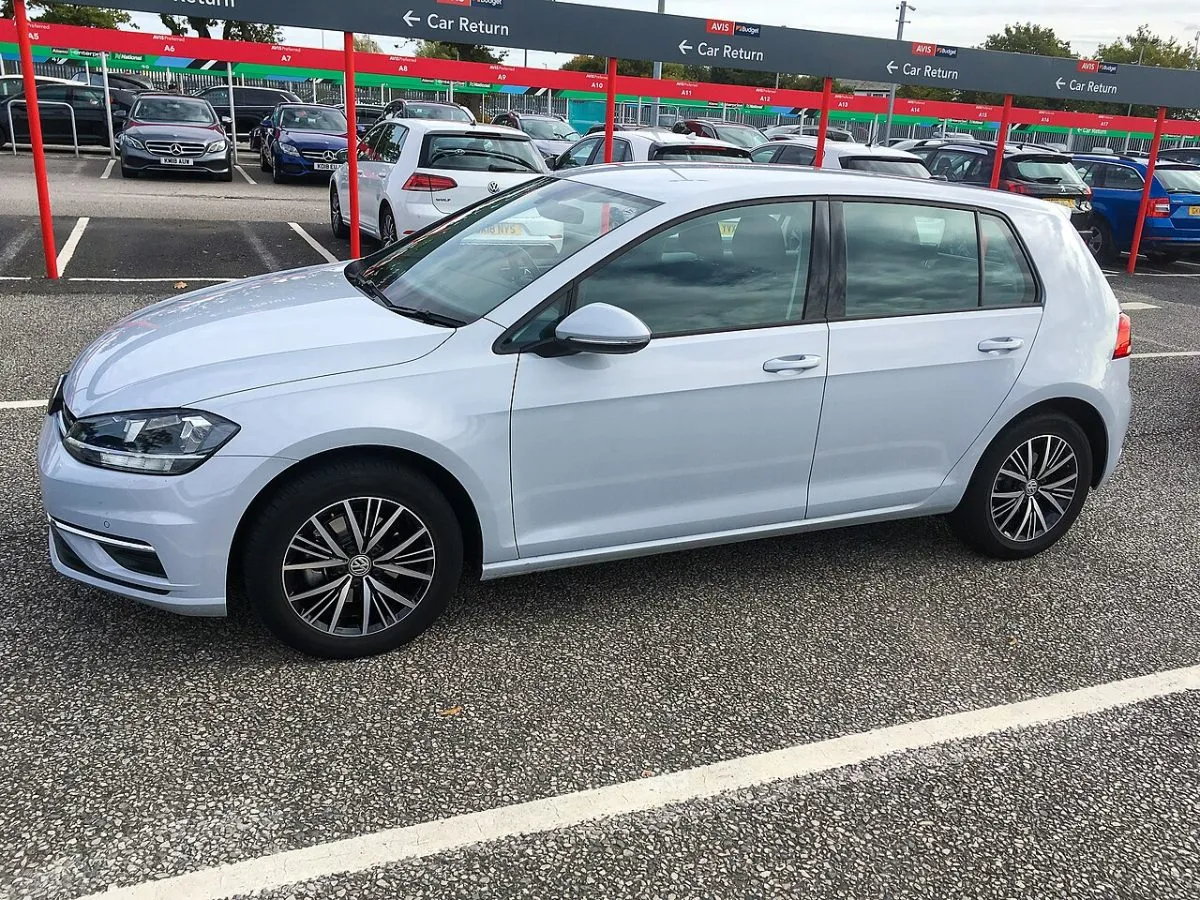 Een balie van een autoverhuurder op een Engels vliegveld, met de rij en de borden erboven.